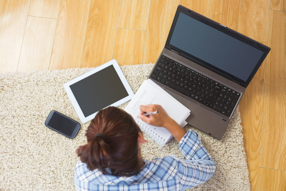 young student using table & notbook for homework