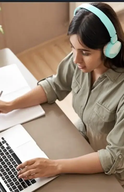 Girl using headphone on Laptop