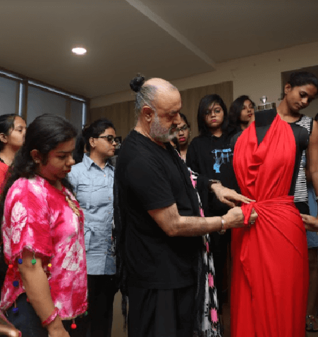 Mentor teaching students about fashion designing